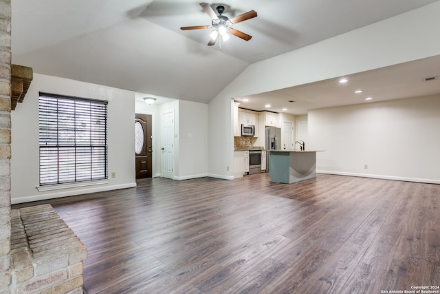 unfurnished living room with lofted ceiling, dark hardwood / wood-style floors, ceiling fan, and sink