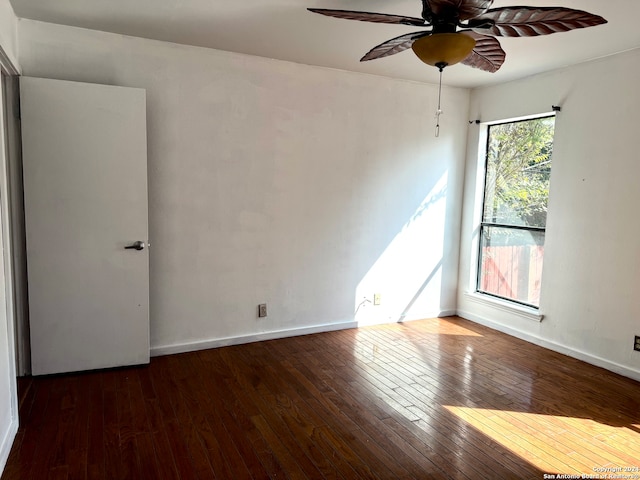 empty room with dark wood-type flooring and ceiling fan