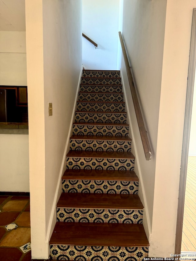 stairs with hardwood / wood-style flooring