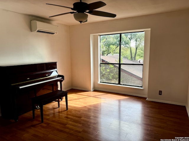 miscellaneous room featuring light hardwood / wood-style flooring, an AC wall unit, and ceiling fan