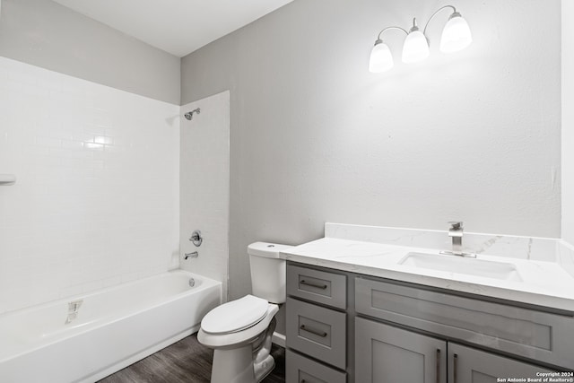 full bathroom with hardwood / wood-style floors, vanity, toilet, and shower / bathtub combination