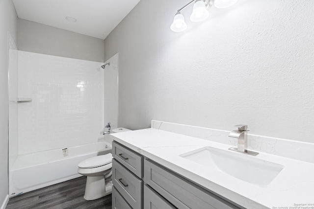 full bathroom featuring hardwood / wood-style flooring, vanity, toilet, and shower / bathtub combination