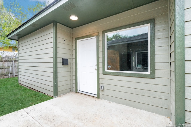 entrance to property featuring a patio