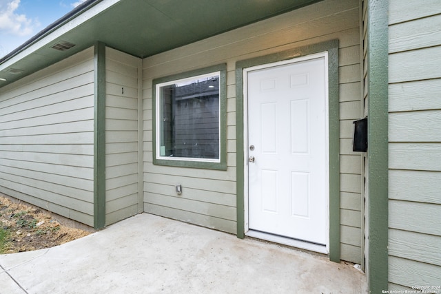 doorway to property with a patio area