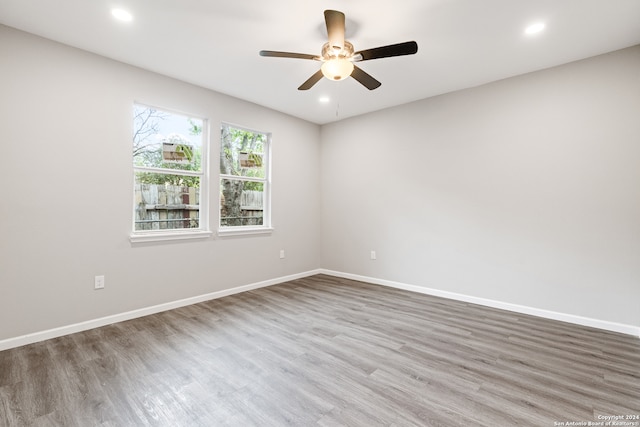 spare room featuring hardwood / wood-style flooring and ceiling fan