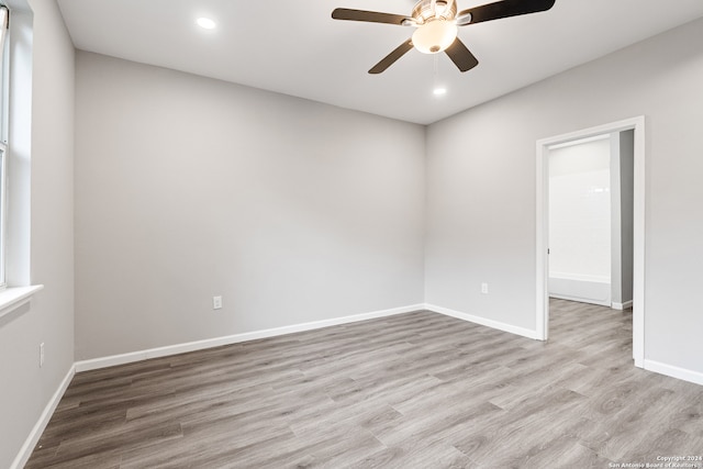 spare room featuring ceiling fan and light hardwood / wood-style flooring