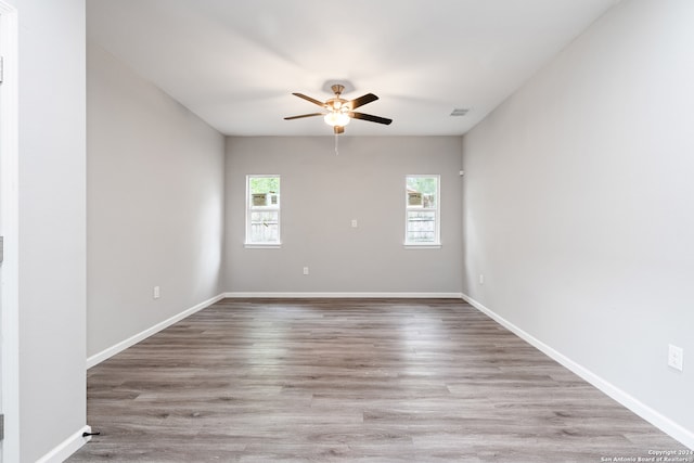 spare room with light hardwood / wood-style floors and ceiling fan