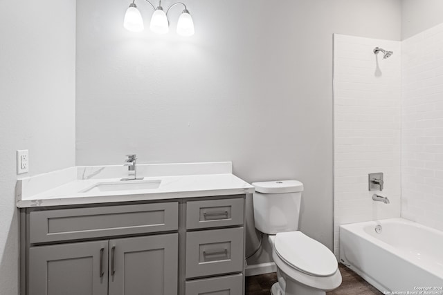 full bathroom featuring washtub / shower combination, vanity, and toilet