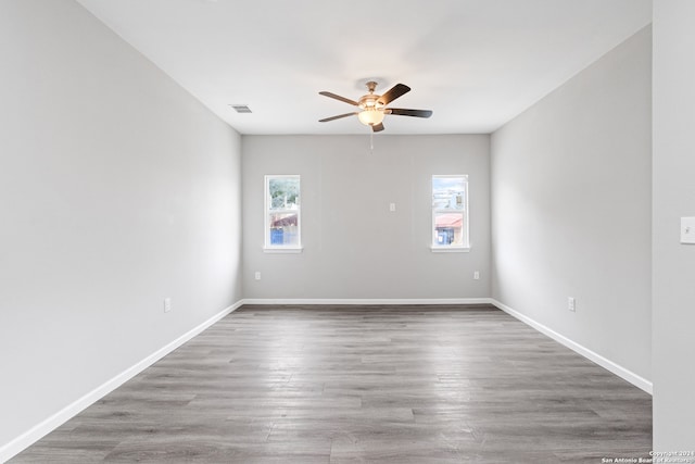 spare room featuring hardwood / wood-style flooring and ceiling fan