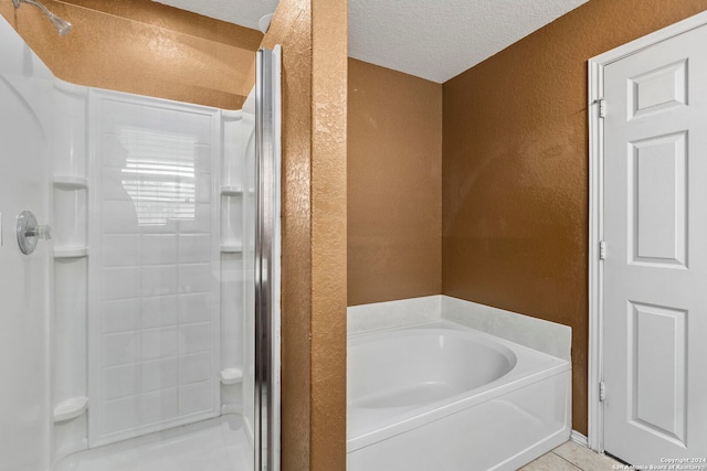 bathroom with tile patterned flooring, a textured ceiling, and independent shower and bath