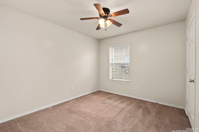 empty room featuring ceiling fan and carpet floors