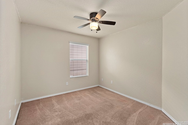 empty room featuring ceiling fan and carpet flooring