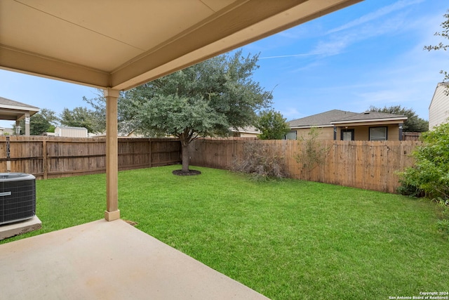 view of yard featuring central AC unit and a patio