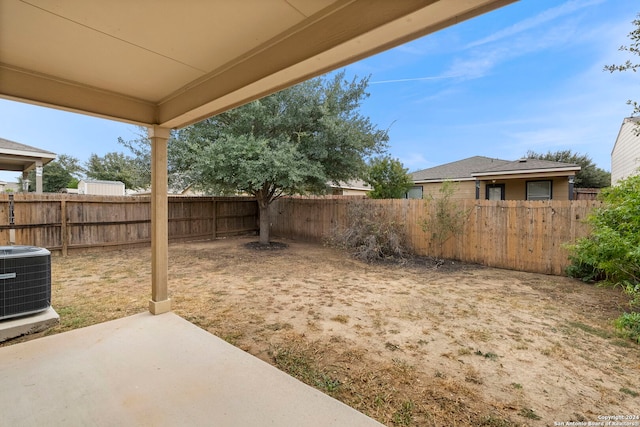 view of yard with cooling unit and a patio area