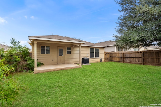 back of property featuring central AC, a yard, and a patio area