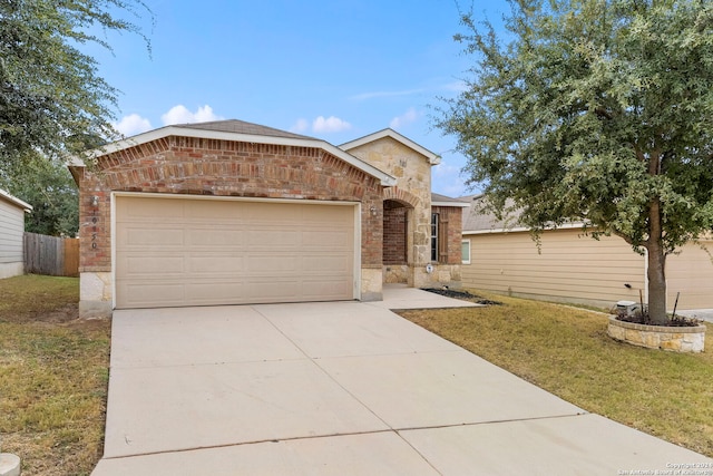 view of front facade featuring a garage and a front lawn