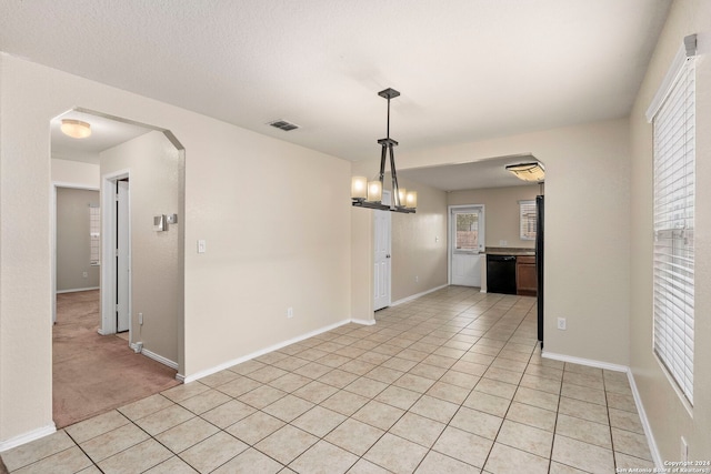 unfurnished dining area featuring light tile patterned floors