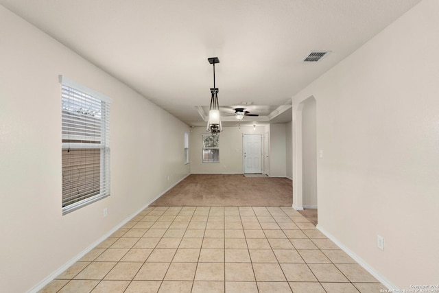 interior space with light tile patterned floors and ceiling fan