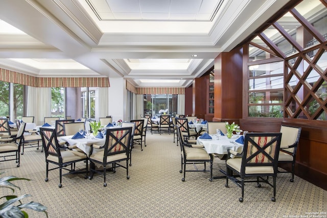 carpeted dining space featuring ornamental molding