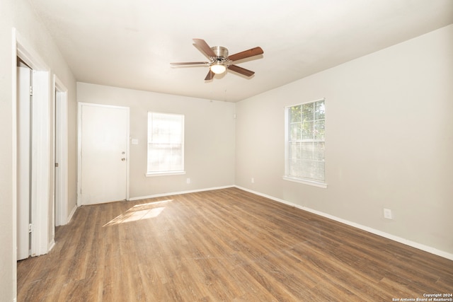 unfurnished room with hardwood / wood-style flooring and ceiling fan