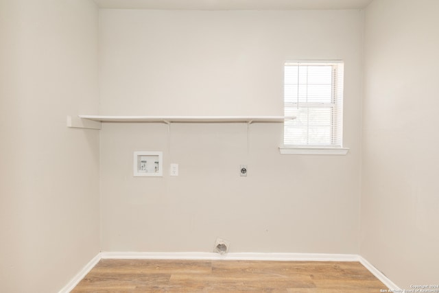 laundry room with hookup for a washing machine, electric dryer hookup, and light hardwood / wood-style flooring