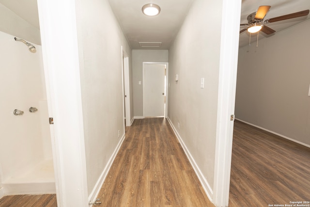 corridor with dark hardwood / wood-style flooring