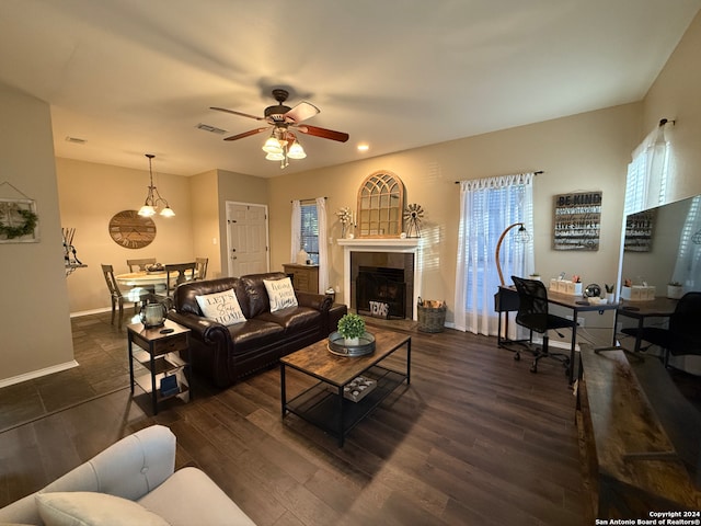 living room with a ceiling fan, dark wood-type flooring, baseboards, recessed lighting, and a tiled fireplace