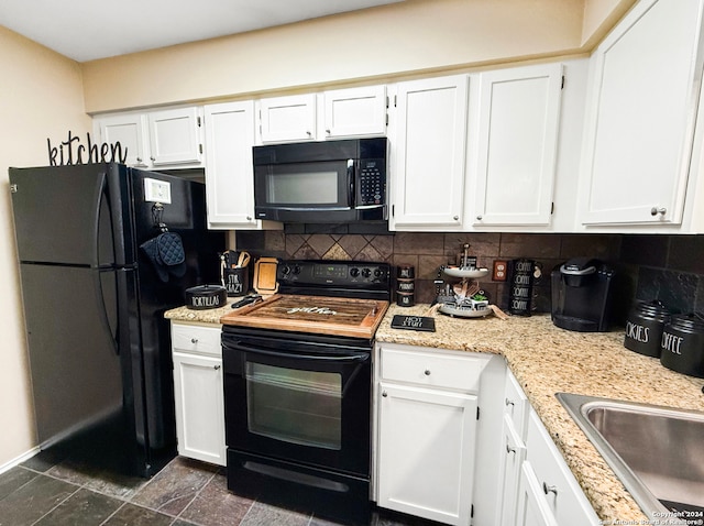 kitchen featuring black appliances, white cabinetry, light stone counters, and backsplash