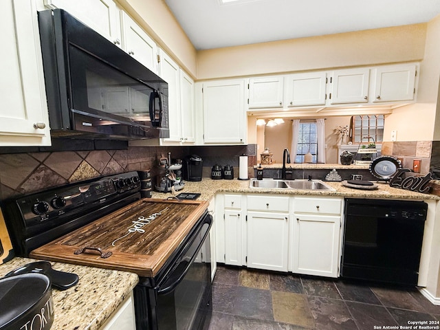 kitchen featuring white cabinetry, black appliances, sink, and backsplash