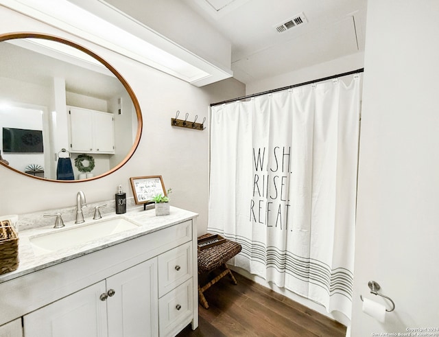 bathroom with vanity and hardwood / wood-style floors