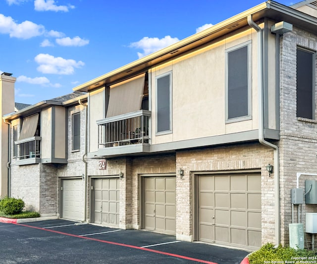 exterior space with a balcony and a garage