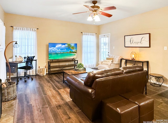 living room featuring ceiling fan, dark hardwood / wood-style floors, and a healthy amount of sunlight