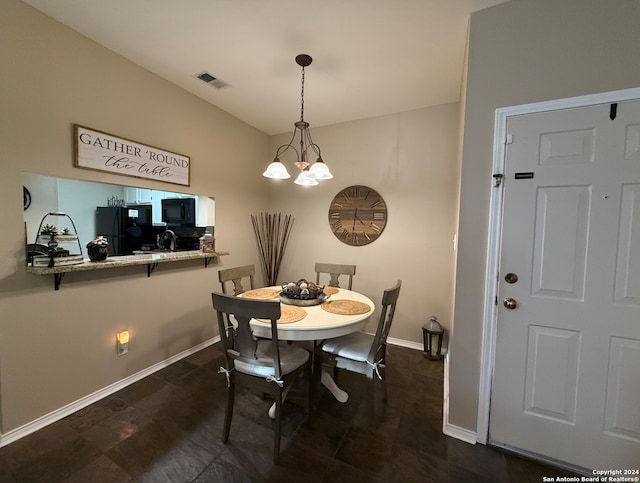 dining room featuring baseboards and a chandelier