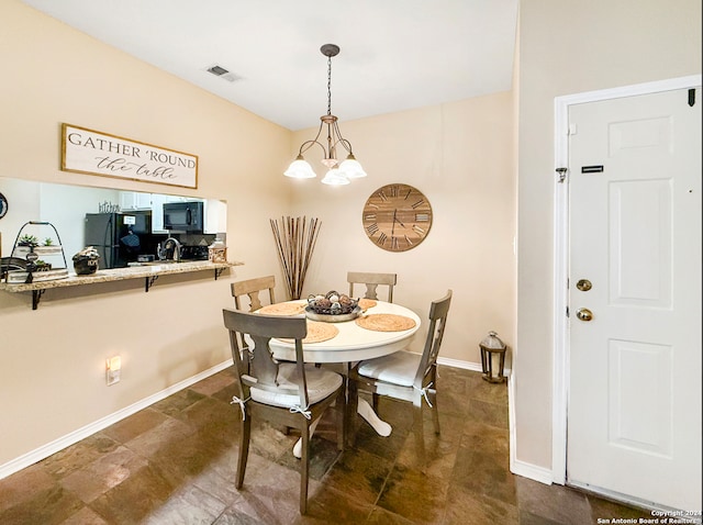 dining space with an inviting chandelier