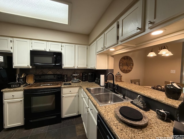 kitchen with black appliances, a sink, backsplash, white cabinetry, and light stone counters