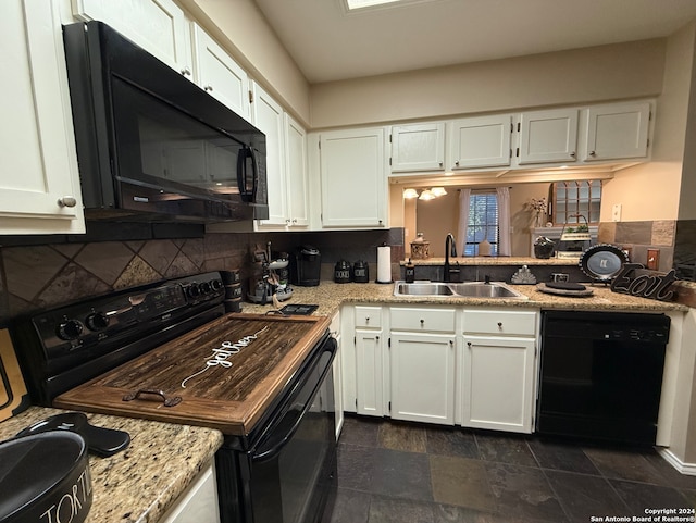 kitchen with black appliances, a sink, backsplash, and white cabinets