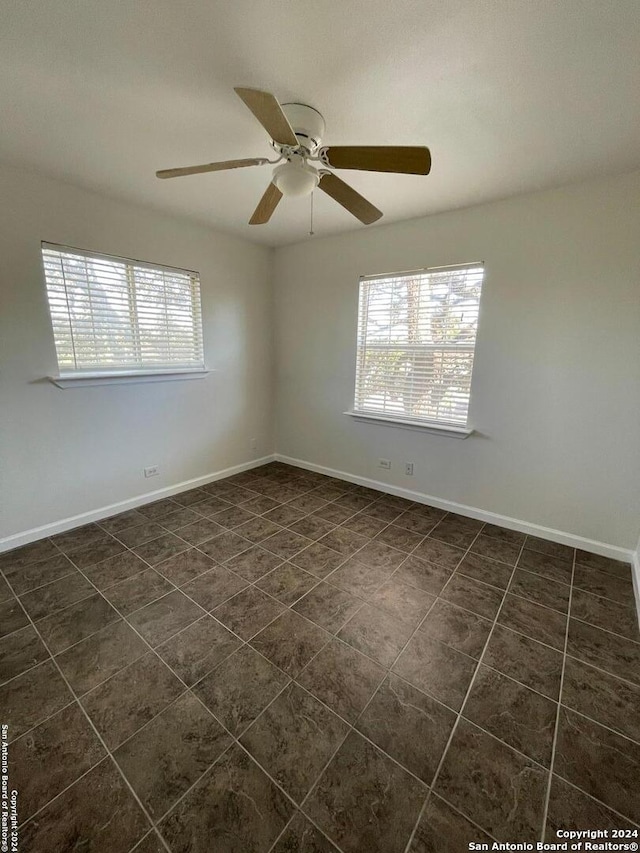 tiled empty room with ceiling fan