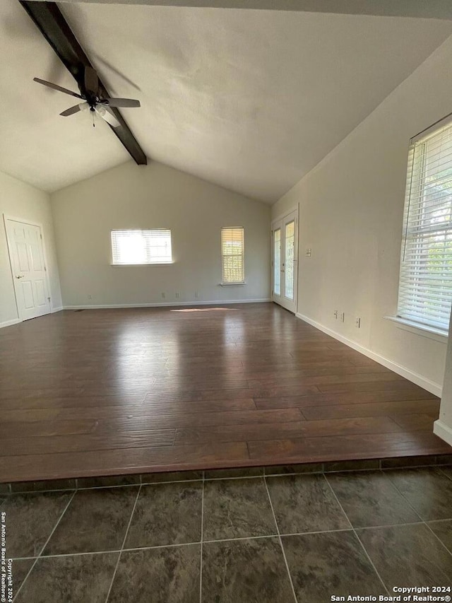 unfurnished room with lofted ceiling with beams, plenty of natural light, and dark hardwood / wood-style flooring