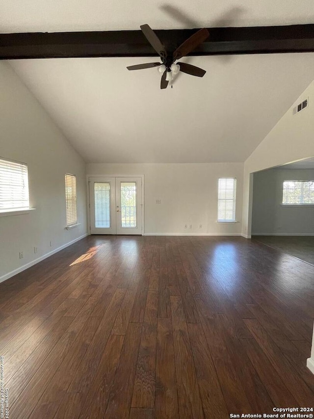 unfurnished living room featuring lofted ceiling with beams, dark hardwood / wood-style flooring, a healthy amount of sunlight, and ceiling fan