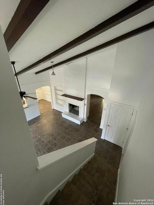 interior space with beamed ceiling and ceiling fan