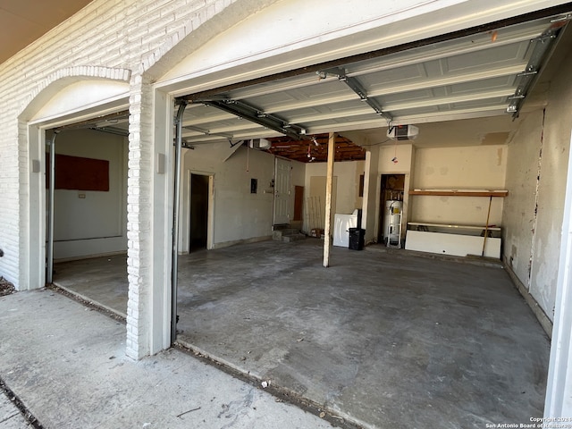 garage featuring a garage door opener and water heater