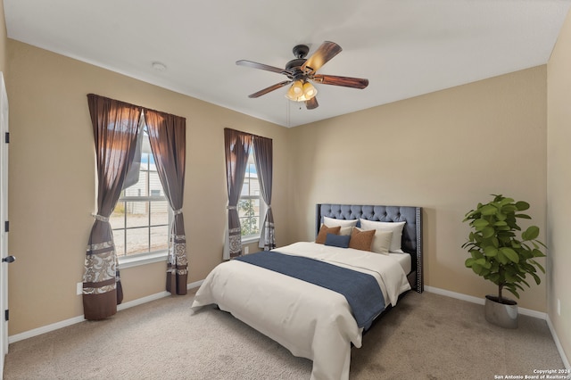 bedroom with ceiling fan and light carpet