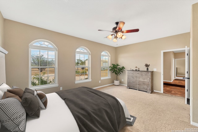 bedroom with ceiling fan and light carpet