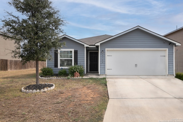 ranch-style house featuring a garage and a front yard