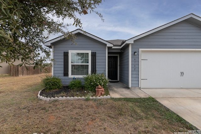 view of front of house with a front lawn and a garage