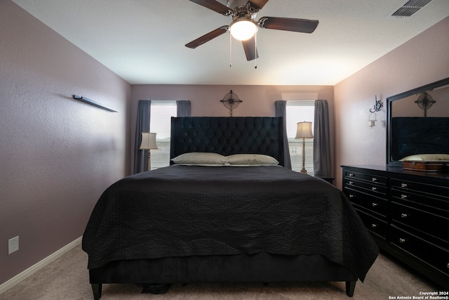 bedroom with light carpet and ceiling fan