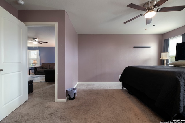 bedroom featuring light colored carpet and ceiling fan