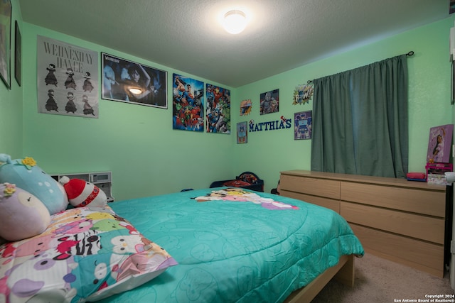 bedroom with a textured ceiling and carpet flooring