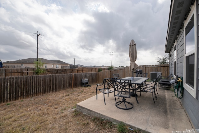 view of yard with central AC unit and a patio