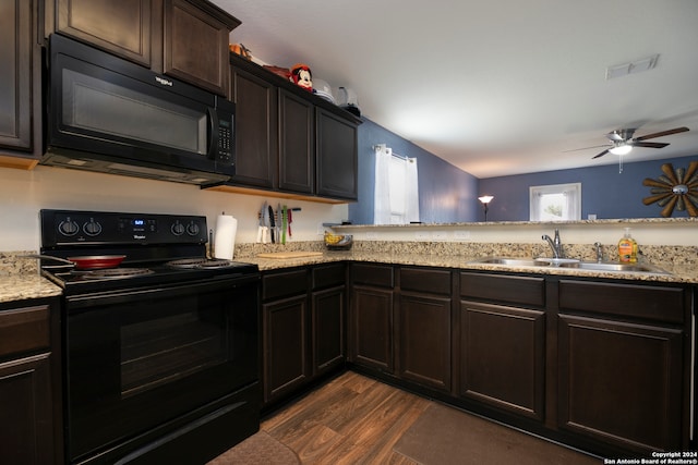 kitchen with black appliances, dark brown cabinetry, sink, dark wood-type flooring, and ceiling fan